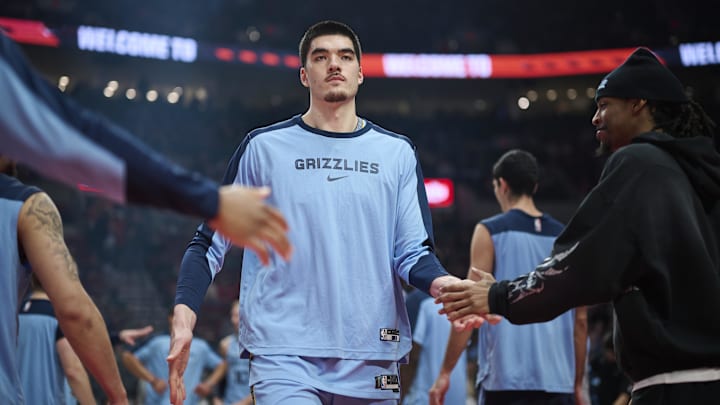 Memphis Grizzlies center Zach Edey (14) high fives teammates during introductions