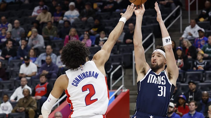 Jan 31, 2025; Detroit, Michigan, USA;  Dallas Mavericks guard Klay Thompson (31) shoots over Detroit Pistons guard Cade Cunningham (2) in the first half at Little Caesars Arena. Mandatory Credit: Rick Osentoski-Imagn Images