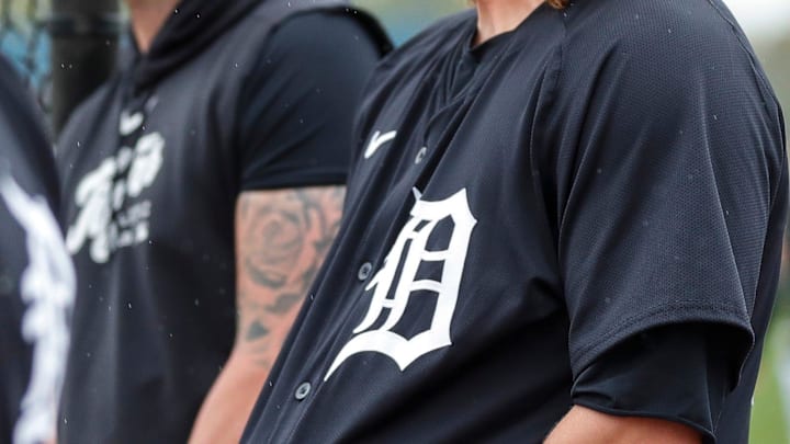 Detroit Tigers pitcher Andrew Chafin hides his glove in the jersey as he watches warm up during spring training at TigerTown in Lakeland, Fla. on Saturday, Feb. 17, 2024.