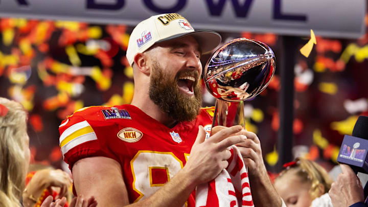 Feb 11, 2024; Paradise, Nevada, USA; Kansas City Chiefs tight end Travis Kelce (87) celebrates with the Vince Lombardi Trophy after defeating the San Francisco 49ers in Super Bowl LVIII at Allegiant Stadium. Mandatory Credit: Mark J. Rebilas-USA TODAY Sports