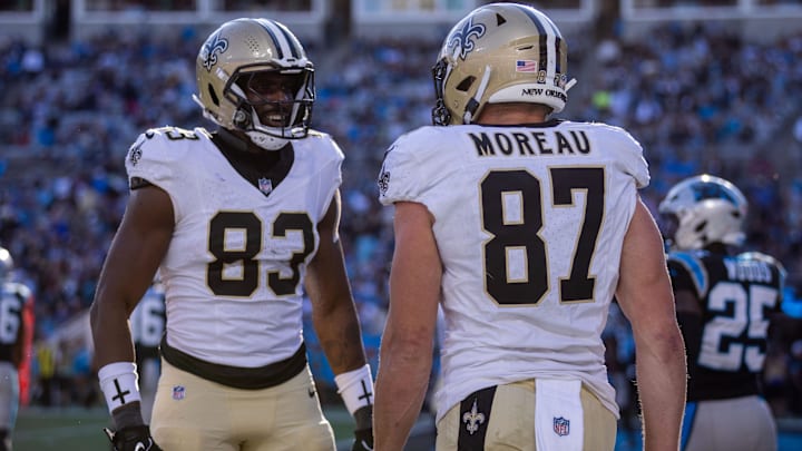 Nov 3, 2024; Charlotte, North Carolina, USA; New Orleans Saints tight end Juwan Johnson (83) celebrates with tight end Foster Moreau (87) after a touchdown against the Carolina Panthers during the fourth quarter at Bank of America Stadium. Mandatory Credit: Scott Kinser-Imagn Images