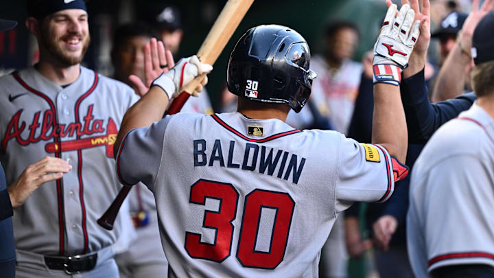 Apr 22, 2026; Washington, District of Columbia, USA;  Atlanta Braves catcher Drake Baldwin (30) celebrates in the dugout after hitting a home run in the first inning against the Washington Nationals at Nationals Park. Mandatory Credit: Jamie Sabau-Imagn Images