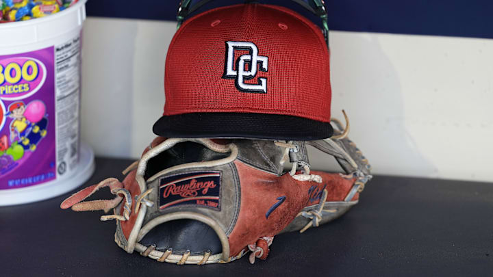 Jul 12, 2024; Milwaukee, Wisconsin, USA;  An Washington Nationals hat and glove sit in the dugout during batting practice prior to the game against the Milwaukee Brewers at American Family Field. 
