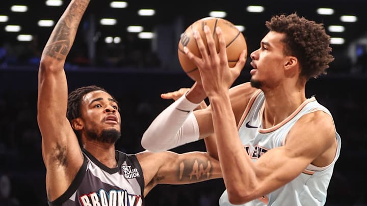 San Antonio Spurs center Victor Wembanyama (1) looks to drive past Brooklyn Nets center Nic Claxton (33) in the second quarter at Barclays Center.
