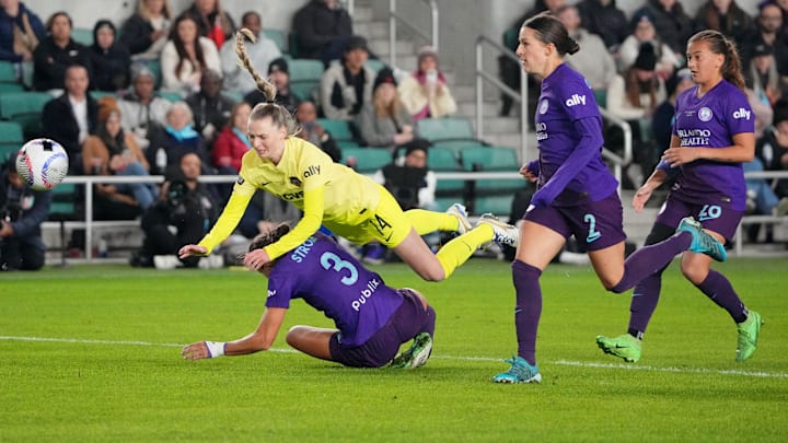 Nov 23, 2024; Kansas City, Missouri, USA; Washington Spirit defender Gabrielle Carle (14) falls over Orlando Pride defender Kylie Strom (3) during the second half in the 2024 NWSL Championship match at CPKC Stadium. Mandatory Credit: Denny Medley-Imagn Images