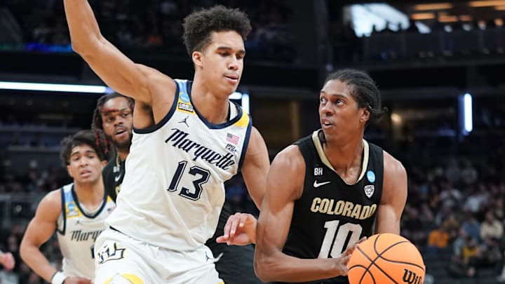 Mar 24, 2024; Indianapolis, IN, USA; Colorado Buffaloes forward Cody Williams (10) dribbles against Marquette Golden Eagles forward Oso Ighodaro (13) during the first half at Gainbridge FieldHouse. Mandatory Credit: Robert Goddin-USA TODAY Sports
