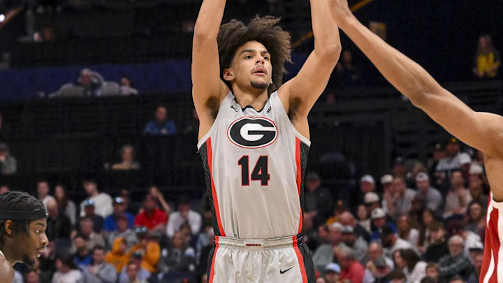 Mar 12, 2025; Nashville, TN, USA;  Georgia Bulldogs forward Asa Newell (14) shoots a three point basket against the Oklahoma Sooners during the first half at Bridgestone Arena. Mandatory Credit: Steve Roberts-Imagn Images