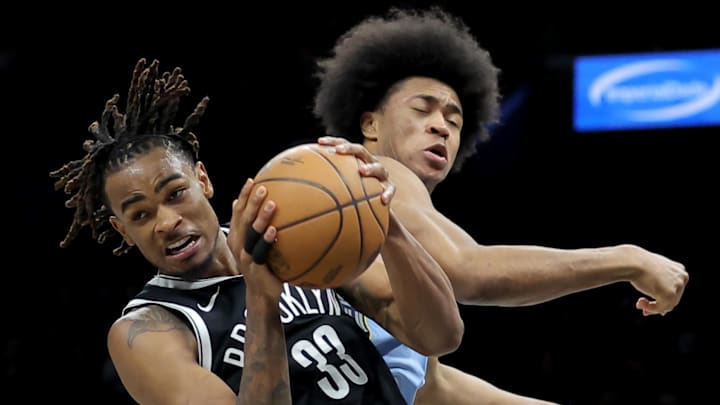 Mar 9, 2026; Brooklyn, New York, USA; Brooklyn Nets center Nic Claxton (33) grabs a rebound against Memphis Grizzlies forward Jaylen Wells (0) during the second quarter at Barclays Center. Mandatory Credit: Brad Penner-Imagn Images