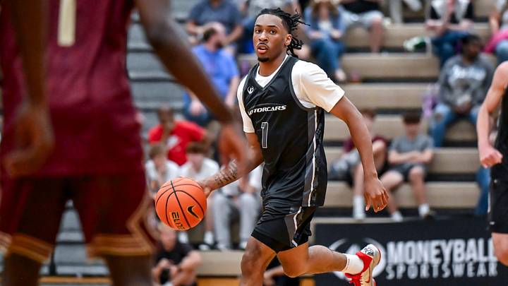 Team Motorcars and Michigan State's Carlos Medlock Jr. moves the ball against Team Faygo during the Moneyball Pro-Am on Tuesday, June 23, 2026, at Holt High School.