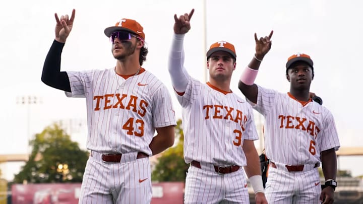 Texas Longhorns Aiden Robbins, Casey Borba and Anthony Pack Jr. throw up the Hook 'Em Horns.