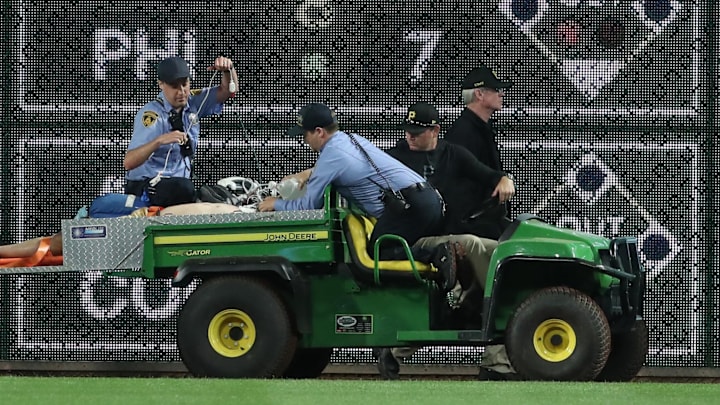 Apr 30, 2025; Pittsburgh, Pennsylvania, USA; Stadium security and Pittsburgh Pirates medical personnel cart a fan who fell from the stands to the field to an ambulance as the Pirates batted against the Chicago Cubs during the seventh inning at PNC Park. Apr 30, 2025; Pittsburgh, Pennsylvania, USA; Stadium security and Pittsburgh Pirates medical personnel cart a fan who fell from the stands to the field to an ambulance as the Pirates batted against the Chicago Cubs during the seventh inning at PNC Park.