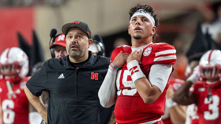 Nebraska Head Coach Matt Rhule and quarterback Dyaln Raiola look up at the scoreboard during the second quarter against Illinois.