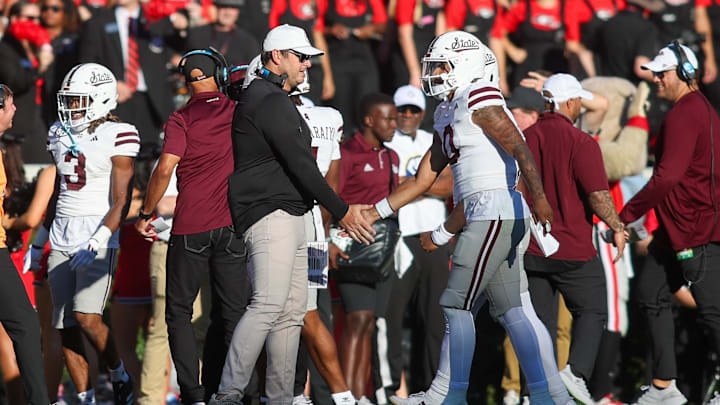 Oct 12, 2024; Athens, Georgia, USA; Mississippi State Bulldogs head coach Jeff Lebby celebrates with quarterback Michael Van Buren Jr. (0) after a touchdown against the Georgia Bulldogs in the second quarter at Sanford Stadium. Mandatory Credit: Brett Davis-Imagn Images