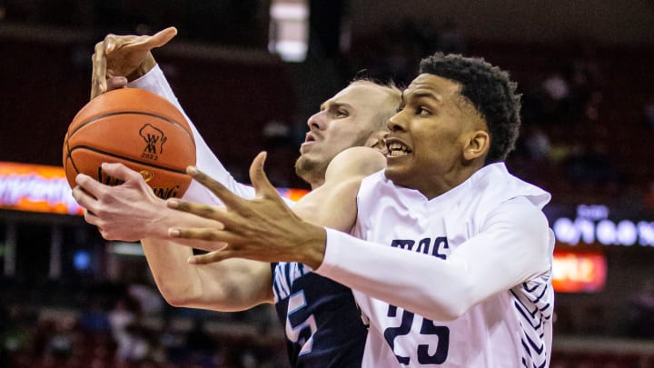 Milwaukee Academy of Science's Davion Hannah (25) battles for a rebound with Roncalli's Luke Pautz (5) during the WIAA Division 4 state boys basketball championship at the Kohl Center in Madison on Saturday, March 19, 2022.

Mjs Bball State Semifinal 3008