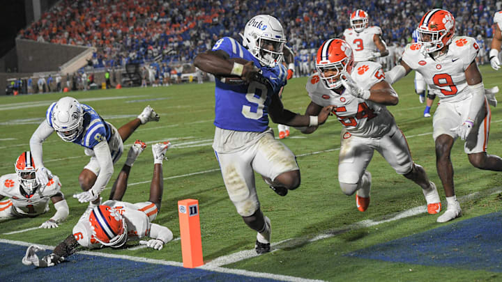 Sep 4, 2023; Durham, North Carolina, USA; Duke Blue Devils running back Jaquez Moore (9) scores near Clemson linebacker Jeremiah Trotter Jr. (54) during the fourth quarter of the season opening game at Wallace Wade Stadium in Durham, N.C. Mandatory Credit: Ken Ruinard-USA TODAY Sports
