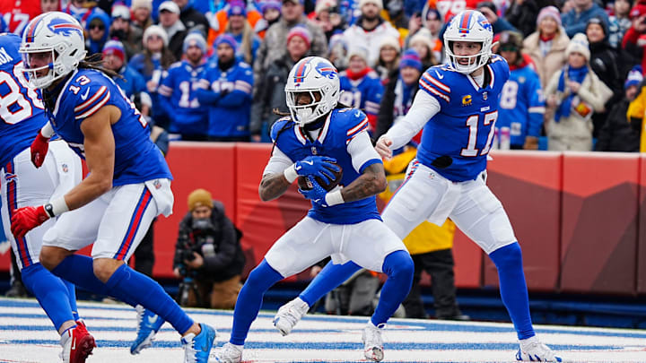 Buffalo Bills quarterback Josh Allen hands the ball off to Buffalo Bills running back James Cook Buffalo Bills quarterback Josh Allen hands the ball off to Buffalo Bills running back James Cook