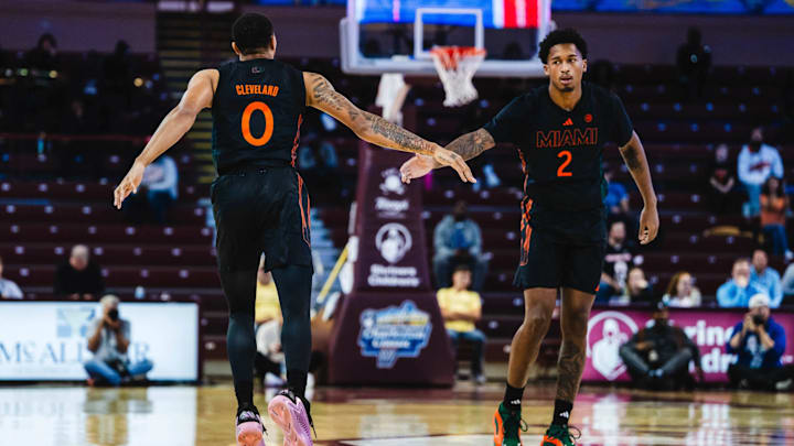 Miami's Matthew Cleveland (0) and Brandon Johnson (2) dapping each other up after a basket against Drake at the 2024 Charleston Classic.