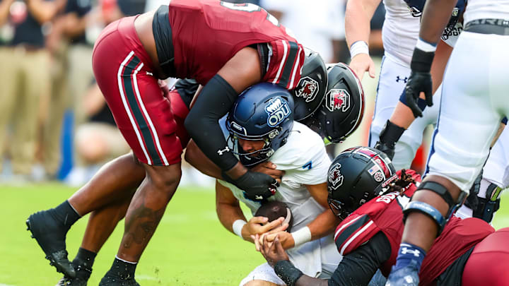 South Carolina football freshman Dylan Stewart sacking the quarterback with an assist from Kyle Kennard and Monkell Goodwine