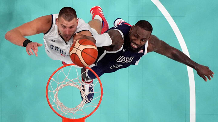 Jul 28, 2024; Villeneuve-d'Ascq, France; Serbia power forward Nikola Jokic (15) and United States guard Lebron James (6) jump for a rebound Jul 28, 2024; Villeneuve-d'Ascq, France; Serbia power forward Nikola Jokic (15) and United States guard Lebron James (6) jump for a rebound