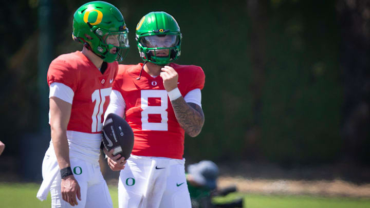 Oregon quarterbacks Luke Moga, left, and Dillon Gabriel during the Ducks’ fall camp Tuesday, Aug. 6, 2024, at the Hatfield-Dowlin Complex in Eugene, Ore.