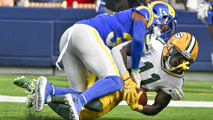 Oct 6, 2024; Inglewood, California, USA; Los Angeles Rams safety Quentin Lake (37) tackles Green Bay Packers wide receiver Jayden Reed (11) during the second quarter at SoFi Stadium. Mandatory Credit: Robert Hanashiro-Imagn Images