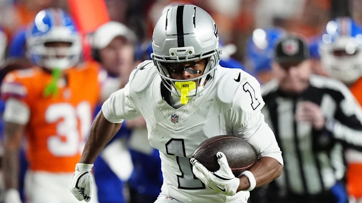 Nov 6, 2025; Denver, Colorado, USA; Las Vegas Raiders wide receiver Tre Tucker (1) runs with the ball after catch against the Denver Broncos during the first half at Empower Field at Mile High. 