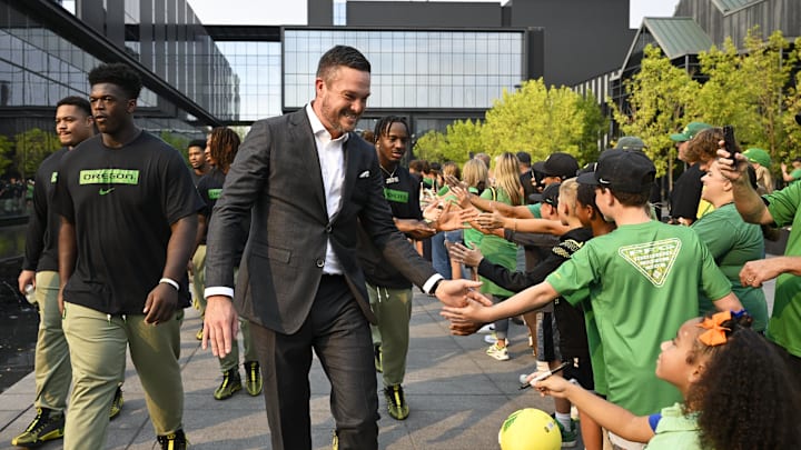 Sep 7, 2024; Eugene, Oregon, USA; Oregon Ducks head coach Dan Lanning high-fives fans as he leads his team before a game against the Boise State Broncos at Autzen Stadium.