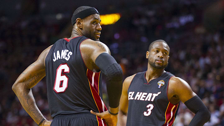 Mar 6, 2013; Miami, FL, USA; Miami Heat small forward LeBron James (6) and Heat shooting guard Dwyane Wade (3) react to some fans during the game against the Orlando Magic at the American Airlines Arena. Mandatory Credit: Scott Rovak-Imagn Images