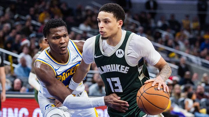 Dec 23, 2025; Indianapolis, Indiana, USA;  Milwaukee Bucks guard Ryan Rollins (13) dribbles the ball while Indiana Pacers guard/forward Bennedict Mathurin (00) defends in the second half at Gainbridge Fieldhouse. Mandatory Credit: Trevor Ruszkowski-Imagn Images