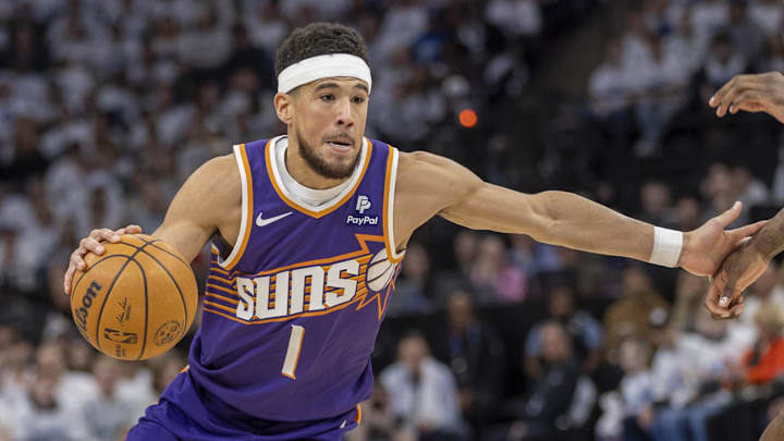 Apr 20, 2024; Minneapolis, Minnesota, USA; Phoenix Suns guard Devin Booker (1) dribbles the ball against the Minnesota Timberwolves in the first half during game one of the first round for the 2024 NBA playoffs at Target Center. Mandatory Credit: Jesse Johnson-USA TODAY Sports