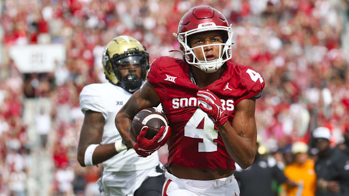 Oct 21, 2023; Norman, Oklahoma, USA; Oklahoma Sooners wide receiver Nic Anderson (4) catches a touchdown pass past UCF Knights defensive back Decorian Patterson (11) during the second quarter at Gaylord Family-Oklahoma Memorial Stadium. Mandatory Credit: Kevin Jairaj-Imagn Images