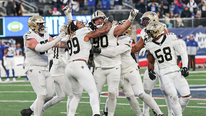 Dec 8, 2024; East Rutherford, New Jersey, USA; New Orleans Saints defensive tackle Bryan Bresee (90) celebrates with teammates after blocking a field goal during the fourth quarter by New York Giants place kicker Graham Gano (not pictured) at MetLife Stadium. Dec 8, 2024; East Rutherford, New Jersey, USA; New Orleans Saints defensive tackle Bryan Bresee (90) celebrates with teammates after blocking a field goal during the fourth quarter by New York Giants place kicker Graham Gano (not pictured) at MetLife Stadium.