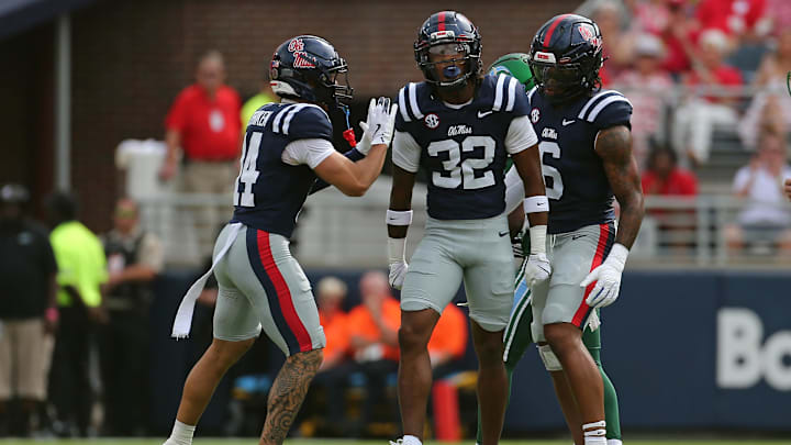 Sep 20, 2025; Oxford, Mississippi, USA; Mississippi Rebels defensive back Kapena Gushiken (14) and linebacker TJ Dottery (6) react with defensive back Chris Graves Jr. (32) after a defensive stop during the first quarter against the Tulane Green Wave at Vaught-Hemingway Stadium. Mandatory Credit: Petre Thomas-Imagn Images Sep 20, 2025; Oxford, Mississippi, USA; Mississippi Rebels defensive back Kapena Gushiken (14) and linebacker TJ Dottery (6) react with defensive back Chris Graves Jr. (32) after a defensive stop during the first quarter against the Tulane Green Wave at Vaught-Hemingway Stadium. Mandatory Credit: Petre Thomas-Imagn Images
