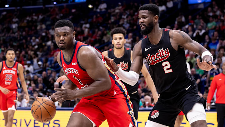Mar 16, 2024; New Orleans, Louisiana, USA;  New Orleans Pelicans forward Zion Williamson (1) dribbles against Portland Trail Blazers center Deandre Ayton (2) during the second half at Smoothie King Center. Mandatory Credit: Stephen Lew-Imagn Images