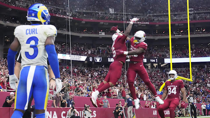 Arizona Cardinals running back James Conner (6) celebrates his touchdown run with running back Trey Benson (33) during the third quarter against the Los Angeles Rams at State Farm Stadium.