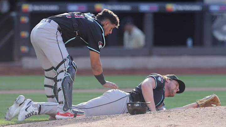 Jun 1, 2024; New York City, New York, USA; Arizona Diamondbacks relief pitcher Kevin Ginkel (37) reacts as catcher Gabriel Moreno (14) checks on him after he was hit by a comebacker by New York Mets left fielder Brandon Nimmo (not pictured) during the sixth inning at Citi Field. Mandatory Credit: Brad Penner-Imagn Images Jun 1, 2024; New York City, New York, USA; Arizona Diamondbacks relief pitcher Kevin Ginkel (37) reacts as catcher Gabriel Moreno (14) checks on him after he was hit by a comebacker by New York Mets left fielder Brandon Nimmo (not pictured) during the sixth inning at Citi Field. Mandatory Credit: Brad Penner-Imagn Images
