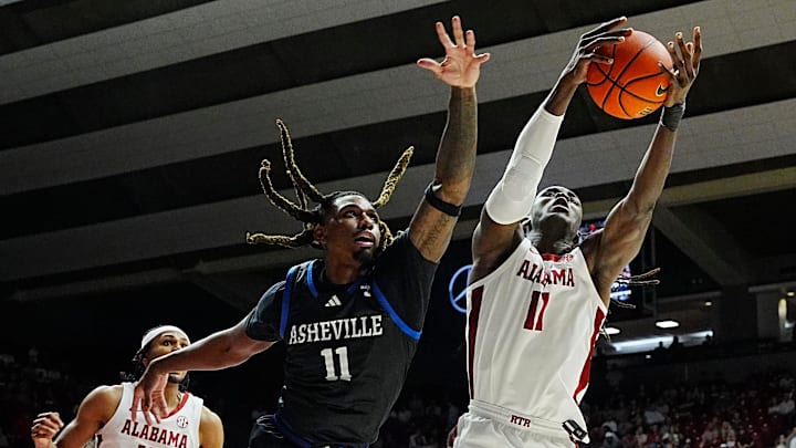 Nov 4, 2024; Tuscaloosa, Alabama, USA; UNC Asheville forward Greg Gantt Jr. (11) rebounds against Alabama center Clifford Omoruyi (11) at Coleman Coliseum.
