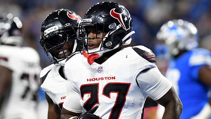 Aug 23, 2025; Detroit, Michigan, USA; Houston Texans running back Woody Marks (27) celebrates with teammates after scoring a touchdown against the Detroit Lions in the second quarter at Ford Field. 