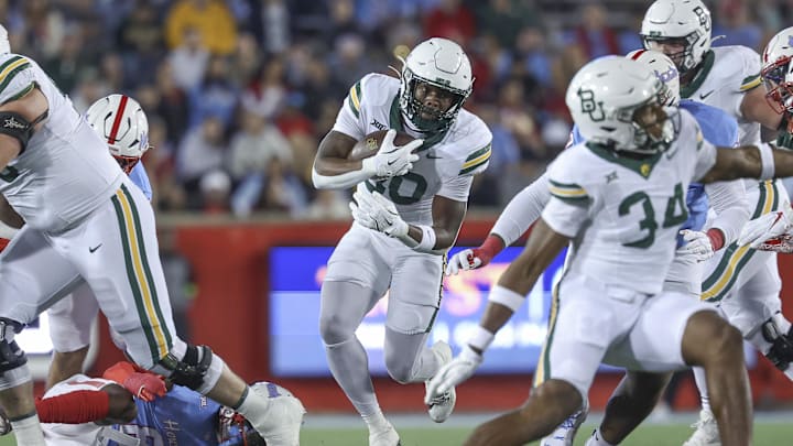 Nov 23, 2024; Houston, Texas, USA; Baylor Bears running back Bryson Washington (30) runs with the ball during the first quarter against the Houston Cougars at TDECU Stadium. Mandatory Credit: Troy Taormina-Imagn Images