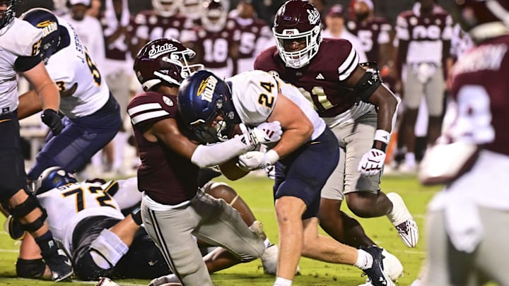 Sep 14, 2024; Starkville, Mississippi, USA; Toledo Rockets running back Connor Walendzak (24) runs the ball while defended by Mississippi State Bulldogs safety Isaac Smith (2) at Davis Wade Stadium at Scott Field. Mandatory Credit: Matt Bush-Imagn Images