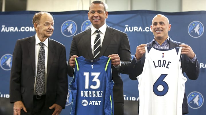Sep 27, 2021; Minneapolis, MN, USA; Current owner Glen Taylor and limited partners and alt-governors for the Minnesota Timberwolves Alex Rodriguez and Mark Lore hold up jerseys after answering questions at a press conference at media day.