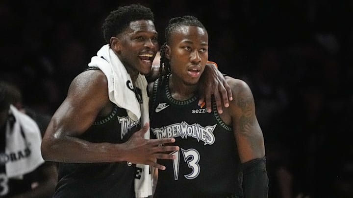 Apr 23, 2026; Minneapolis, Minnesota, USA; Minnesota Timberwolves guard Anthony Edwards (5) talks with guard Ayo Dosunmu (13) during a free throw by the Denver Nuggets in the first quarter at Target Center.