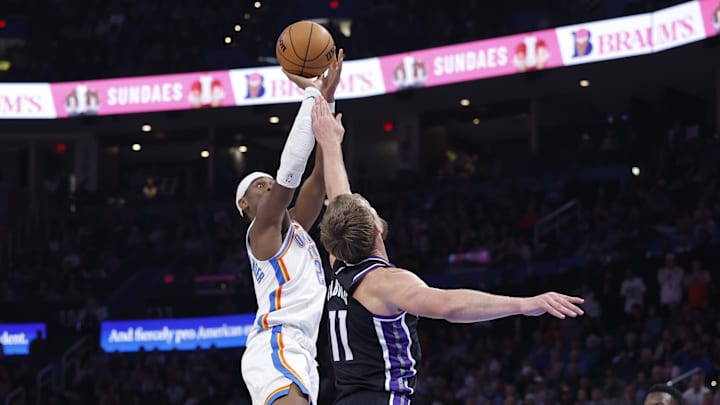 Oct 28, 2025; Oklahoma City, Oklahoma, USA; Oklahoma City Thunder guard Shai Gilgeous-Alexander (2) shoots over Sacramento Kings forward Domantas Sabonis (11) during the second half at Paycom Center. Mandatory Credit: Alonzo Adams-Imagn Images