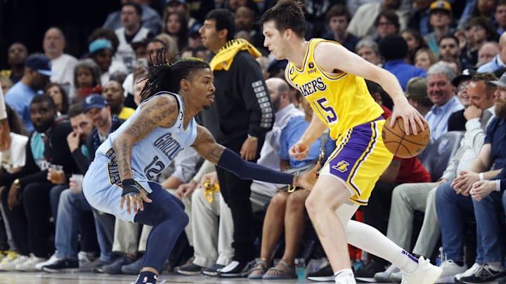 Apr 26, 2023; Memphis, Tennessee, USA; Los Angeles Lakers guard Austin Reaves (15) dribbles as Memphis Grizzlies guard Ja Morant (12) defends during the second half during game five of the 2023 NBA playoffs at FedExForum. Mandatory Credit: Petre Thomas-Imagn Images
