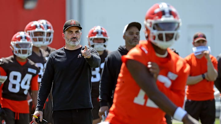 Cleveland Browns coach Kevin Stefanski watches quarterback Shedeur Sanders (12) participate in drills during day two of NFL rookie minicamp at the Cleveland Browns training facility May 10, 2025, in Berea, Ohio.