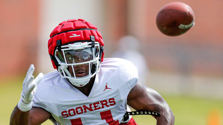 Kobie McKinzie runs drills during an OU football practice. Kobie McKinzie runs drills during an OU football practice.
