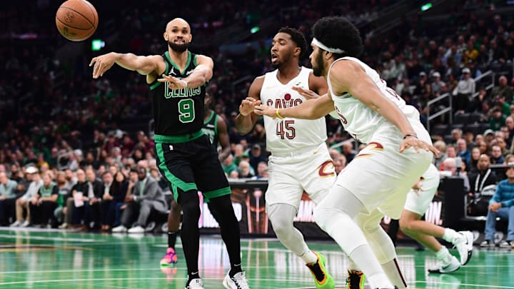 Nov 19, 2024; Boston, Massachusetts, USA; Boston Celtics guard Derrick White (9) passes the ball around Cleveland Cavaliers guard Donovan Mitchell (45) during the first half at TD Garden. Mandatory Credit: Bob DeChiara-Imagn Images