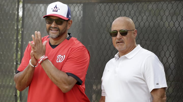 Washington Nationals manager Dave Martinez (4) and general manager Mike Rizzo watch the pitchers warm up during a  spring training workout on Feb. 13, 2020, in West Palm Beach, Fla.