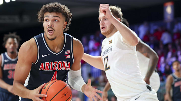 Nov 29, 2024; Paradise Island, Bahamas, BHS;  Arizona Wildcats forward Trey Townsend (4) looks to score as West Virginia Mountaineers guard Tucker DeVries (12) defends during the first half at Imperial Arena at the Atlantis resort. 