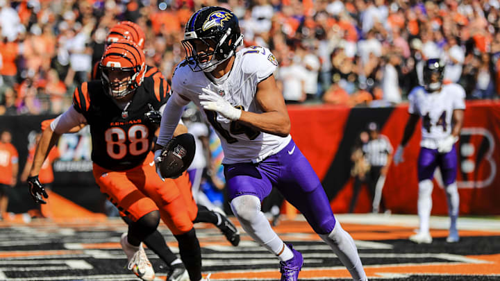 Baltimore Ravens safety Kyle Hamilton (14) runs with the ball against Cincinnati Bengals tight end Mike Gesicki (88) in the first half at Paycor Stadium. 